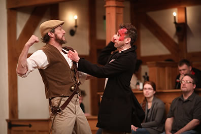 Production photo from American Shakespeare Center's Arden of Faversham at the Blackfriars Playhouse: Shakerag punches at Black Will, the left side of his face covered in blood.